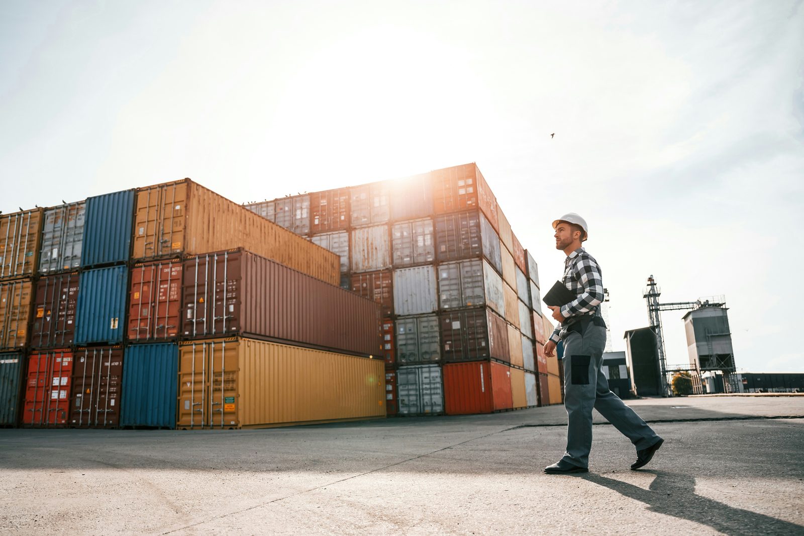 Logistics operator walking through a container yard